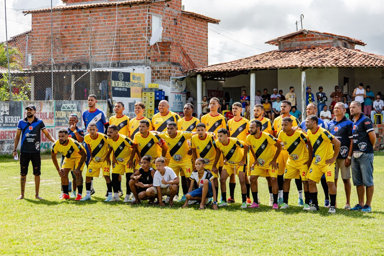 An amateur football team posing together on the pitch